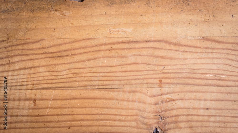 Rough pine wood plank table top with horizontal grain for background Rough pine wood plank table top with horizontal grain for background