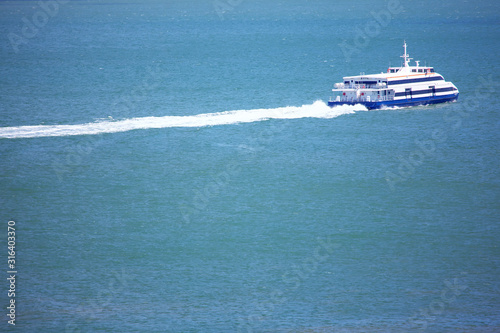 modern passenger boat speeding on the sea © russieseo