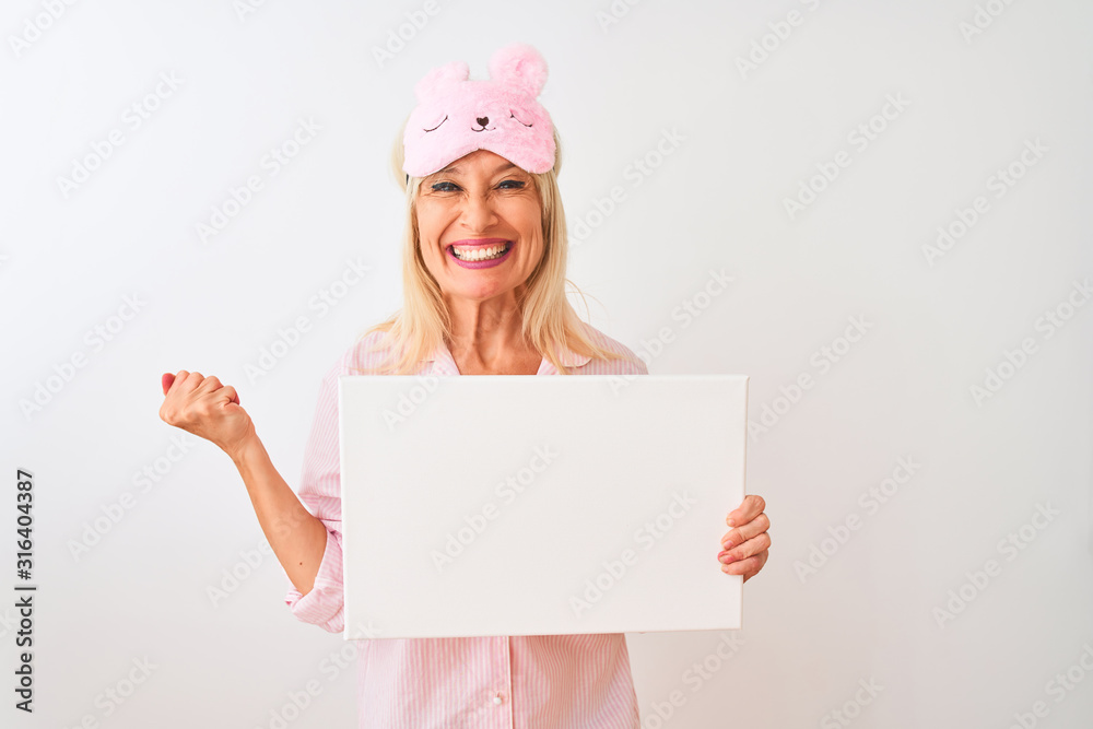 Middle age woman wearing sleep mask pajama holding banner over isolated white background screaming proud and celebrating victory and success very excited, cheering emotion Middle age woman wearing sleep mask pajama holding banner over isolated white background screaming proud and celebrating victory and success very excited, cheering emotion