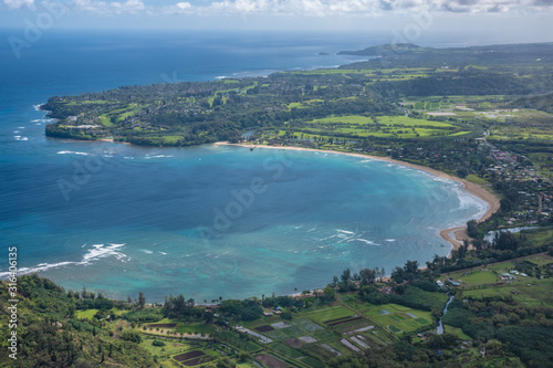 Aerial view of Kauai's lush colorful Hanalei Bay coastal landscape. 