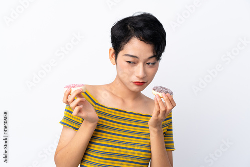 Young Asian girl holding donuts