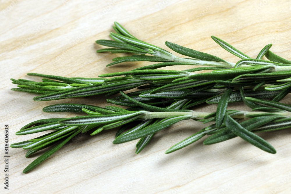 bunch of fresh rosemary on wooden background bunch of fresh rosemary on wooden background