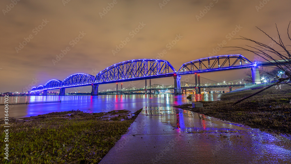 View on Big Four Bridge and Ohio river in Louisville at night with colorful illumination in spring View on Big Four Bridge and Ohio river in Louisville at night with colorful illumination in spring