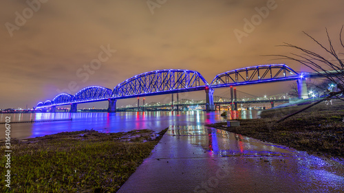 View on Big Four Bridge and Ohio river in Louisville at night with colorful illumination in spring