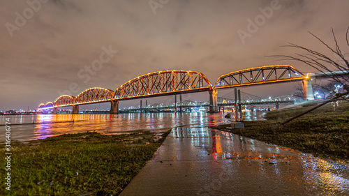 View on Big Four Bridge and Ohio river in Louisville at night with colorful illumination in spring © Aquarius