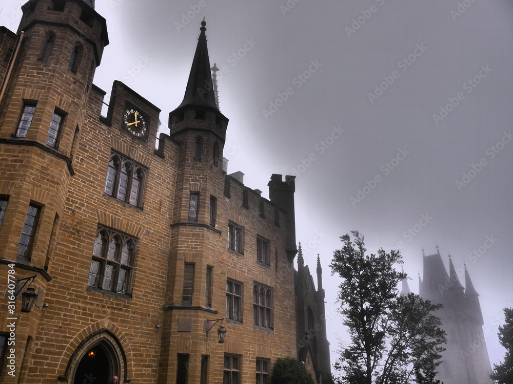 Fototapeta premium Mystic castle in the fog which looks like Hogwarts