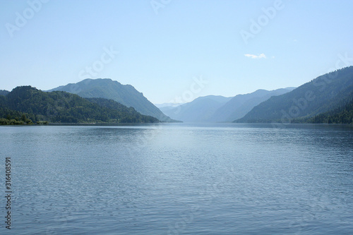 Teletskoye lake in summer in Sunny weather in the mountains covered with green forest