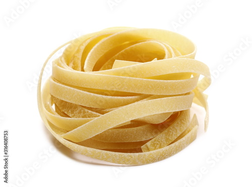 Raw tagliatelle pasta noodles isolated on white background