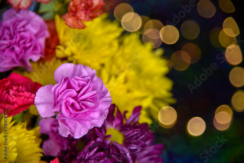 Fototapeta Naklejka Na Ścianę i Meble -  Colorful Flowers (Yellow, Orange, Pink, Purple, Red Carnations, Daisies & Mums) With Bokeh Light Background