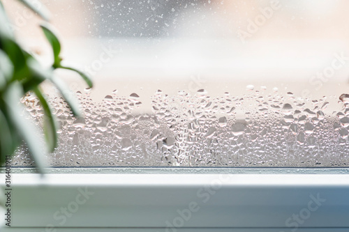 Selective focus on water condensation on window glass. Humidity in the house. Home moisture. photo