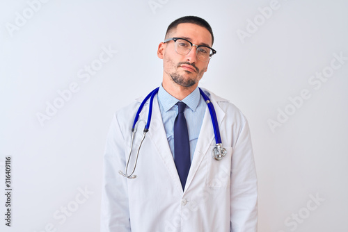 Young doctor man wearing stethoscope over isolated background looking sleepy and tired, exhausted for fatigue and hangover, lazy eyes in the morning.