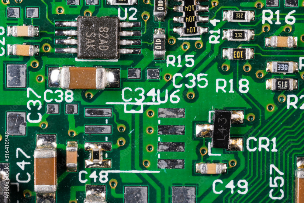 green card computer board with brown microcircuits and various electronic components, top view, macro photo green card computer board with brown microcircuits and various electronic components, top view, macro photo
