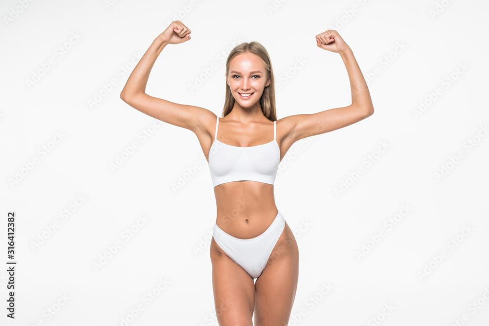 Sport fitness woman flexing show her biceps muscles, young smile girl athletic body, perfect figure wear underwear isolated over white background Sport fitness woman flexing show her biceps muscles, young smile girl athletic body, perfect figure wear underwear isolated over white background