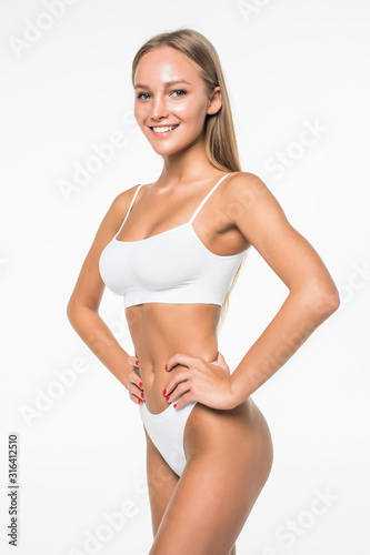 Young woman with beautiful slim perfect body in white bikini isolated white background © F8  \ Suport Ukraine