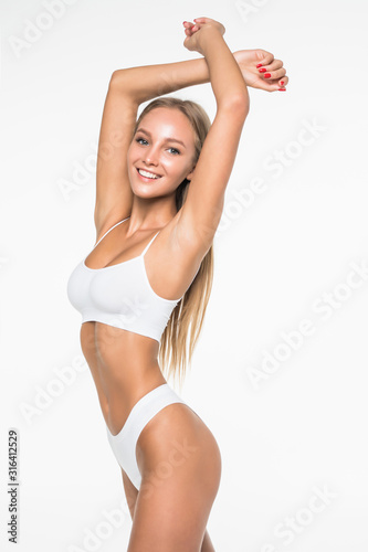 Muscular woman's body in white lingerie isolated on white background