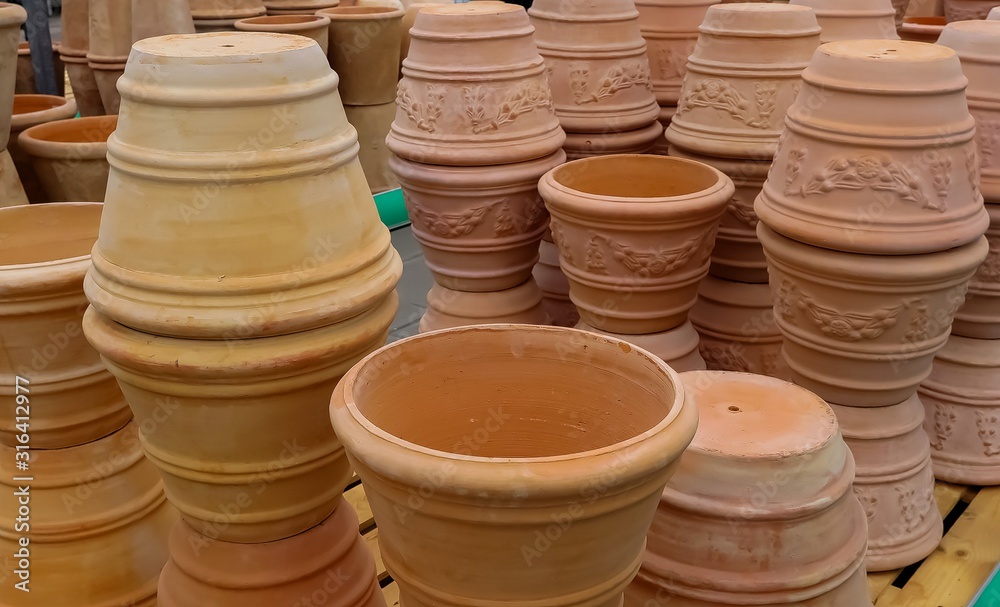 View on isolated stapled pile of brown terra cotta flower pots in german garden centre View on isolated stapled pile of brown terra cotta flower pots in german garden centre