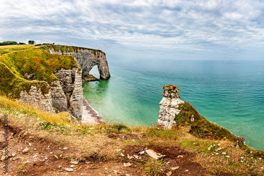 View of natural chalk cliffs of Etretat with visible arche and beach coastline, Normandy, France, Europe