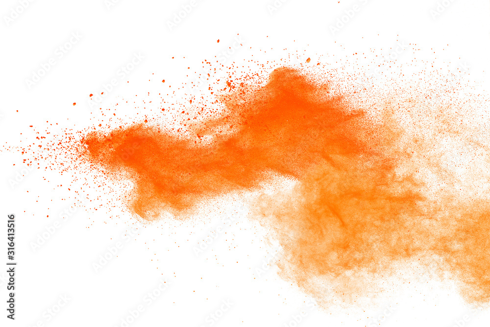 Abstract orange powder explosion. Closeup of orange dust particle splash isolated on white background.