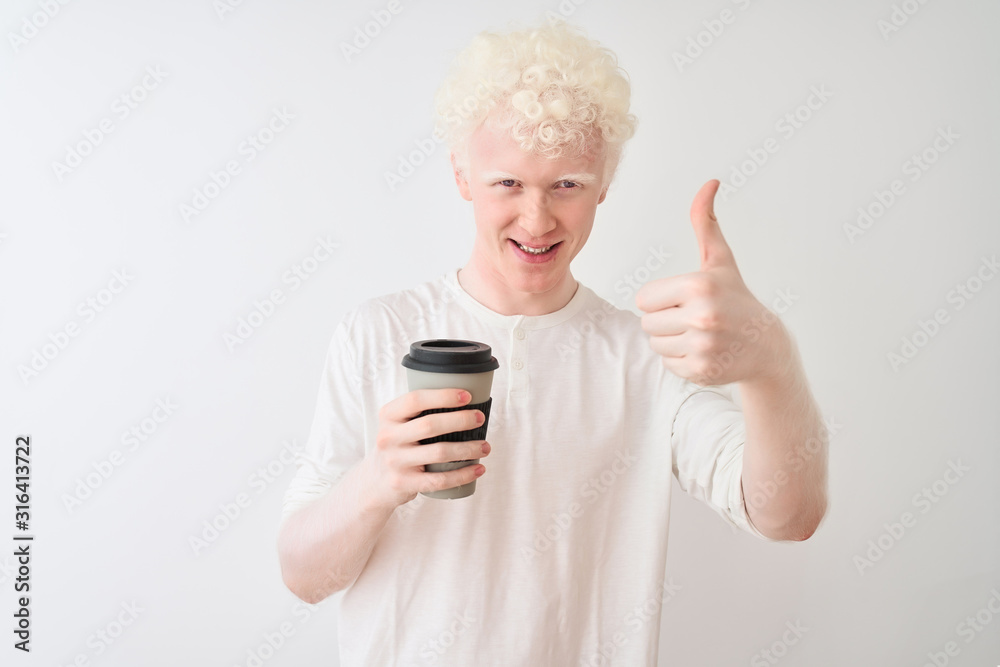 Young albino blond man drinking coffee standing over isolated white background happy with big smile doing ok sign, thumb up with fingers, excellent sign Young albino blond man drinking coffee standing over isolated white background happy with big smile doing ok sign, thumb up with fingers, excellent sign