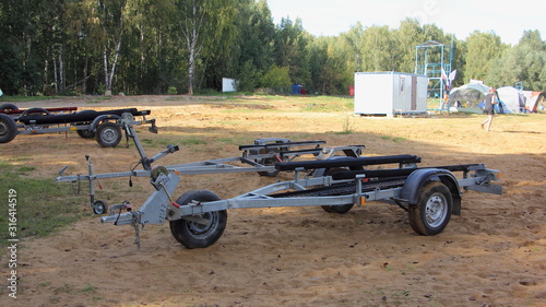 Empty boat trailers parked on the beach on a Sunny summer day, holiday active recreation