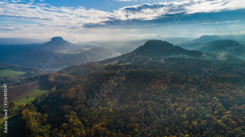 Konigstein Fortress - a Saxon mountain fortress near the town of Konigstein  located on a plateau rising  247 meters above the Elbe level  bathed in fog  aerial view