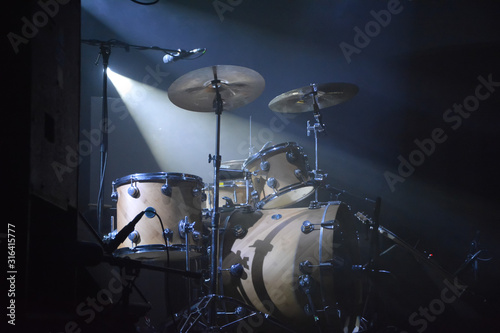 Drumset on a stage with one lightsource photo
