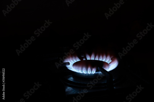 burning gas burner on the stove. Concept - gas wars, shale gas, cook food photo