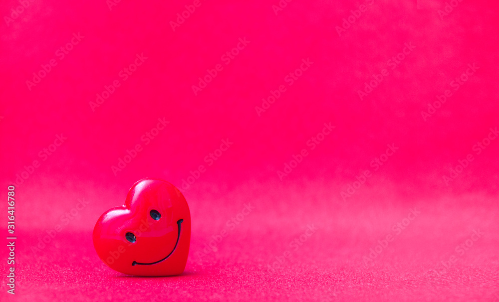smiling red heart on a red-pink shiny background, copy space. Valentine's day concept, place for your text, love concept