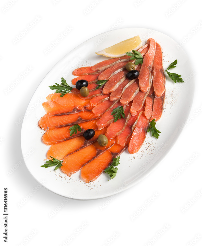 Assorted slices of salted red fish fillet with olives and herbs on a white plate Assorted slices of salted red fish fillet with olives and herbs on a white plate