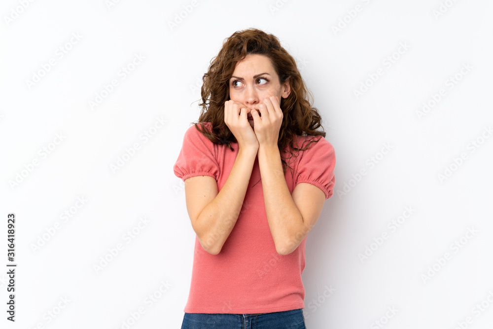 Young pretty woman over isolated background nervous and scared putting hands to mouth Young pretty woman over isolated background nervous and scared putting hands to mouth