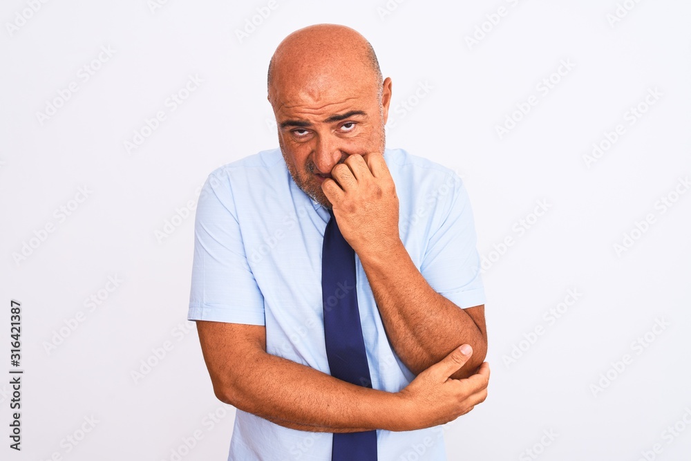 Middle age businessman wearing tie standing over isolated white background looking stressed and nervous with hands on mouth biting nails. Anxiety problem. Middle age businessman wearing tie standing over isolated white background looking stressed and nervous with hands on mouth biting nails. Anxiety problem.