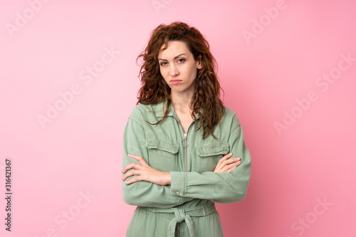 Young pretty woman over isolated pink background feeling upset © luismolinero