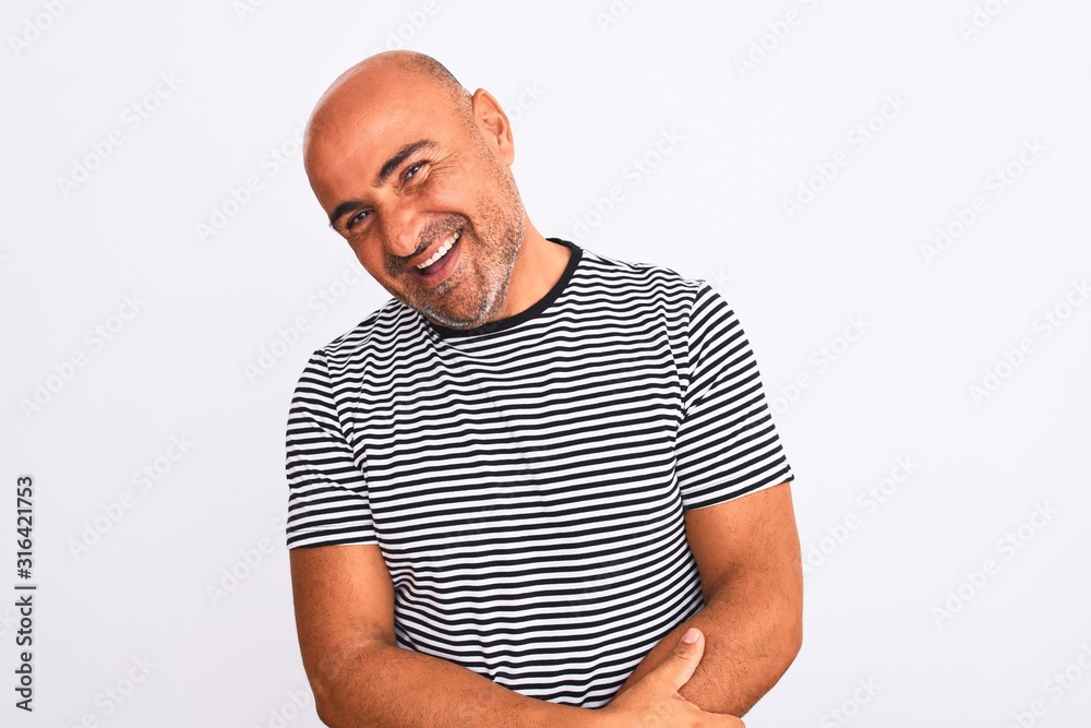 Middle age handsome man wearing striped navy t-shirt over isolated white background looking away to side with smile on face, natural expression. Laughing confident. Middle age handsome man wearing striped navy t-shirt over isolated white background looking away to side with smile on face, natural expression. Laughing confident.