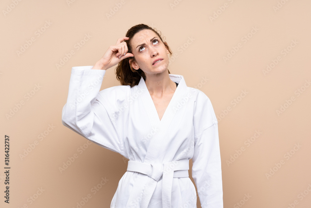 Young woman doing karate having doubts and with confuse face expression Young woman doing karate having doubts and with confuse face expression