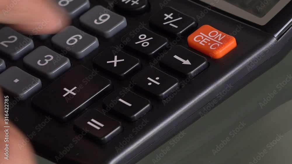 4K close up video of accountant hand using a classic financial calculator and pressing keys to compute numbers. Classic calculator with grey keys and black colour. Investment or investing concept 4K close up video of accountant hand using a classic financial calculator and pressing keys to compute numbers. Classic calculator with grey keys and black colour. Investment or investing concept