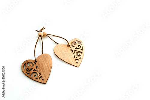 Two handmade wooden carved hearts isolated on white background couple relationship Valentine day concept