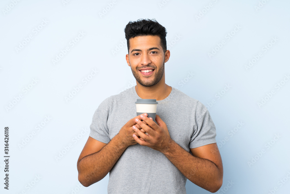 Young handsome man over isolated background holding coffee to take away Young handsome man over isolated background holding coffee to take away