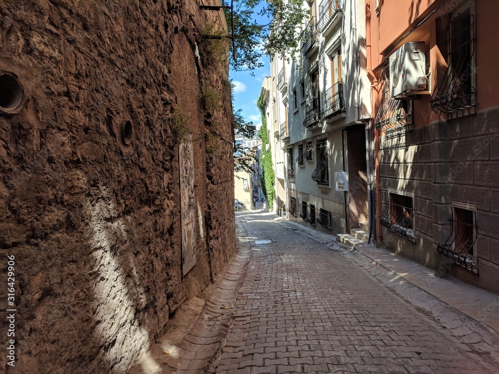 Istanbul, Turkey with cobblestone street and red-brown stone walls
