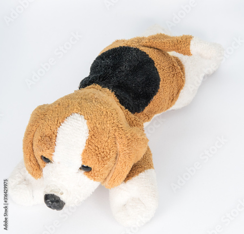 Small brown and black stuffed white dog