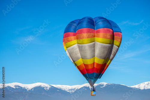 Hot air baloon in the mountain winter