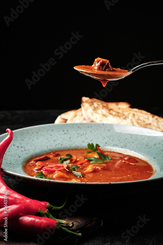 spicy Transcarpathian soup with meat and bread in a plate photo