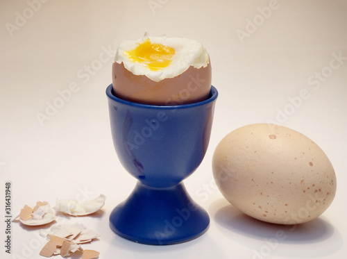 peeled soft-boiled egg in a cup