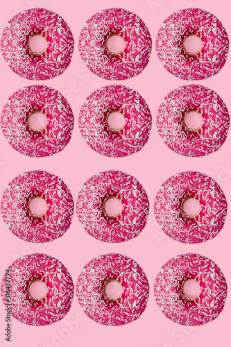 Standout donut. 12 pink donuts. flat lay. pink background