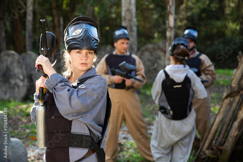 Portrait of young woman paintball player