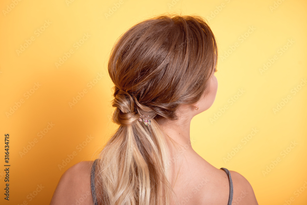 Rear view of female hairstyle middle bun with brown hair. Rear view of female hairstyle middle bun with brown hair.