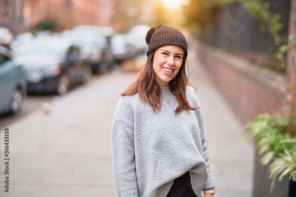 Young beautiful woman smiling happy and confident. Standing with smile on face walking at the city