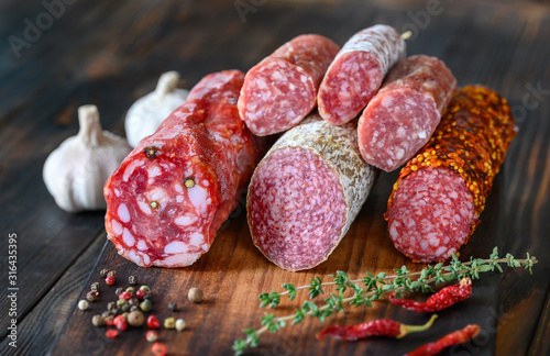 Assortment of salami on the wooden board photo