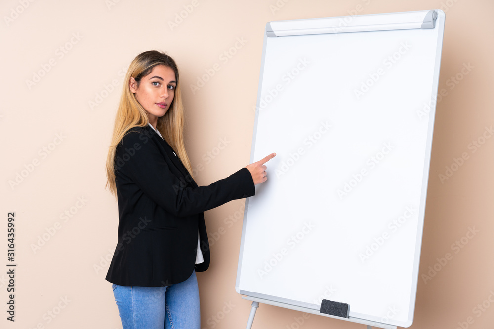 Young Uruguayan woman giving a presentation on white board