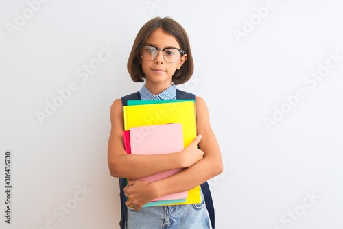 Beautiful student child girl wearing backpack glasses books over isolated white background with a confident expression on smart face thinking serious