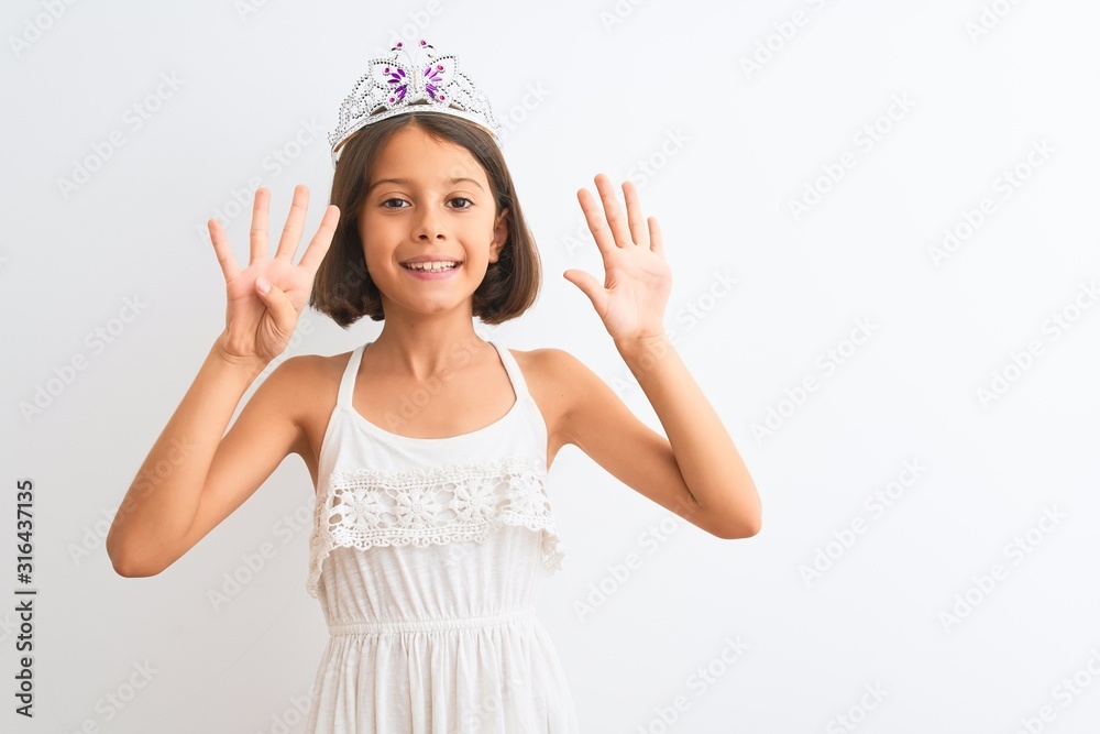 Beautiful child girl wearing princess crown standing over isolated white background showing and pointing up with fingers number nine while smiling confident and happy. Beautiful child girl wearing princess crown standing over isolated white background showing and pointing up with fingers number nine while smiling confident and happy.